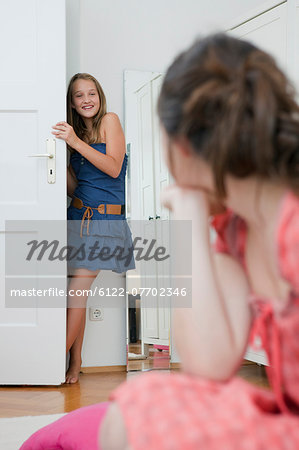 Girl standing in bedroom doorway