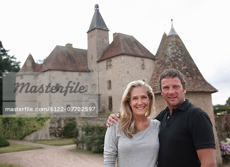 Couple smiling outside medieval castle