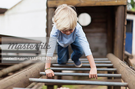 Boy playing on monkey bars