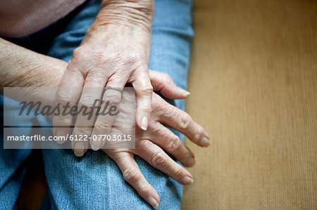 Close up of older woman's folded hands