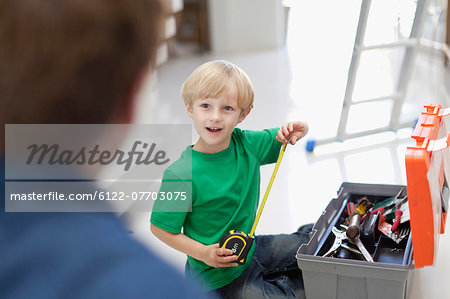 Boy with measuring tape and toolbox
