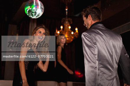 Smiling couple dancing in club