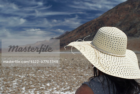 Woman wearing sunhat on rural road