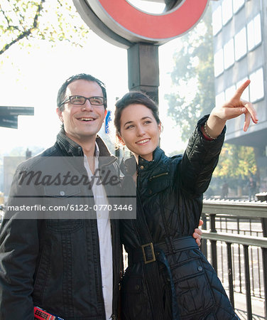 Smiling couple walking on city street