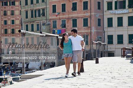 Couple walking along urban pier