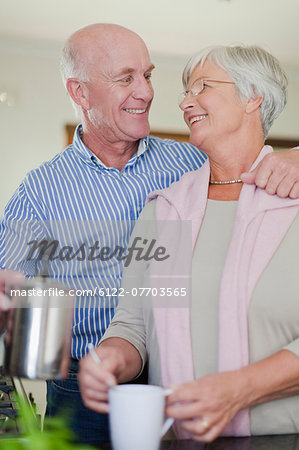 Older couple making coffee together