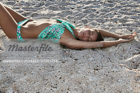 Woman relaxing on sandy beach