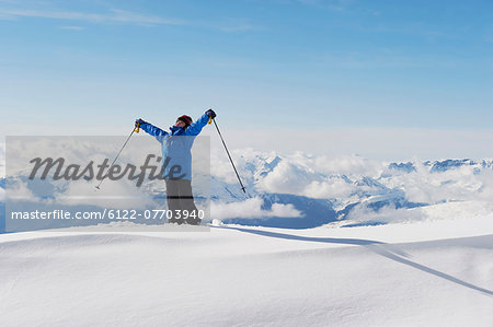 Boy holding ski poles in snow