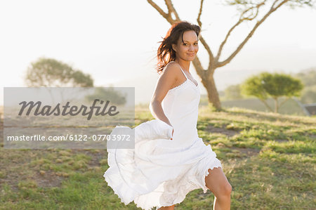 Smiling woman walking in field