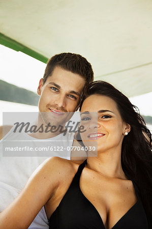 Smiling couple relaxing on boat