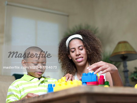 Brother and sister playing with Legos