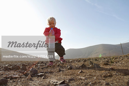 Toddler carrying bottle of water