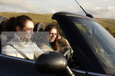 Women driving in rural landscape