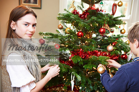 Children decorating Christmas tree