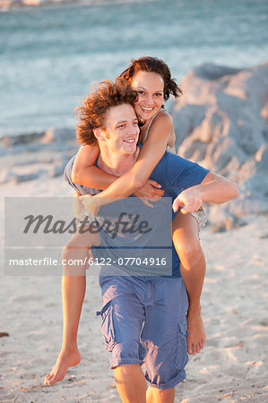 Man carrying girlfriend piggyback