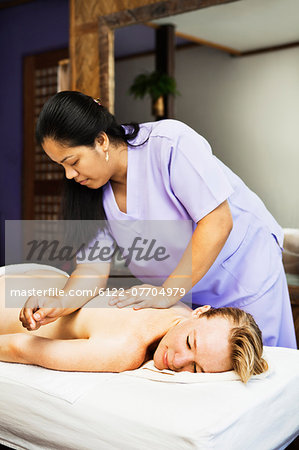 Woman having back massage in spa