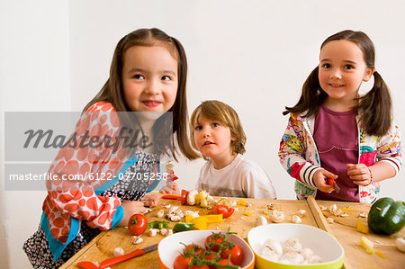 Children cooking together in kitchen