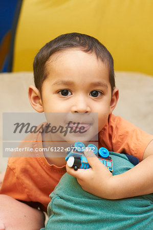 Boy playing with toy train