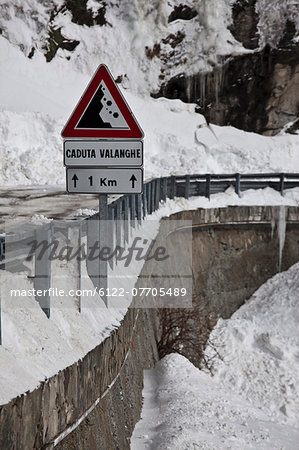 Falling rocks sign in snowy landscape