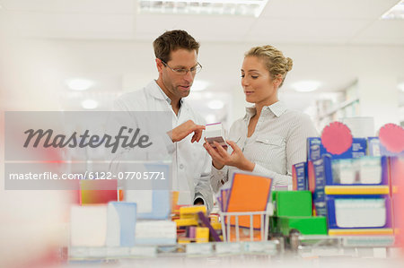 Pharmacist helping patient in store