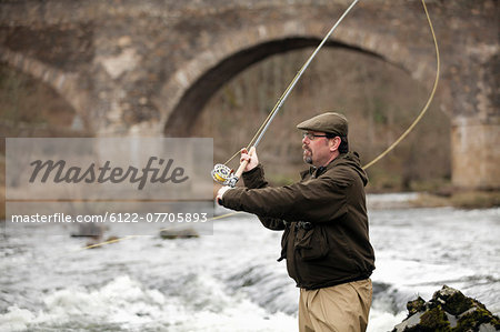 Man fishing for salmon in river
