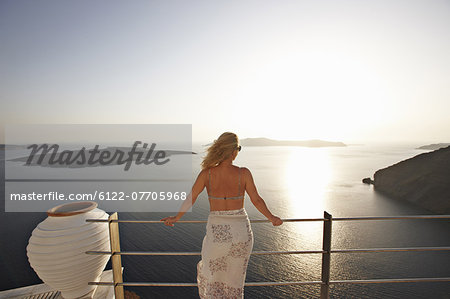 Woman admiring ocean view from balcony