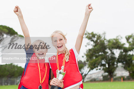 Children cheering with medal