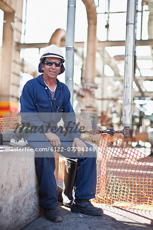 Worker sitting at oil refinery