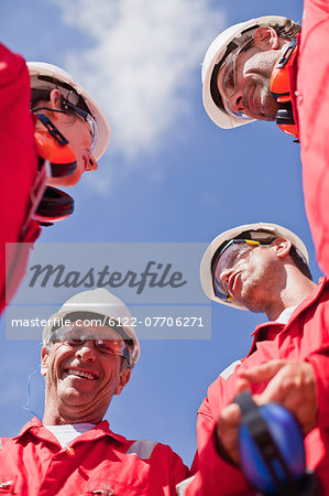 Smiling workers talking outdoors