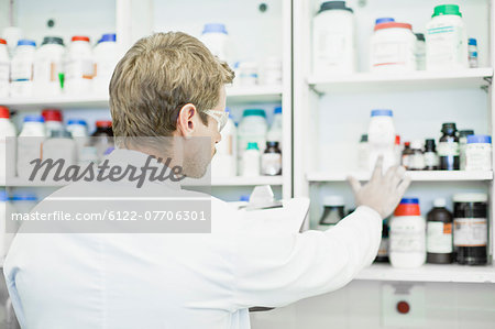 Scientist examining jars in lab