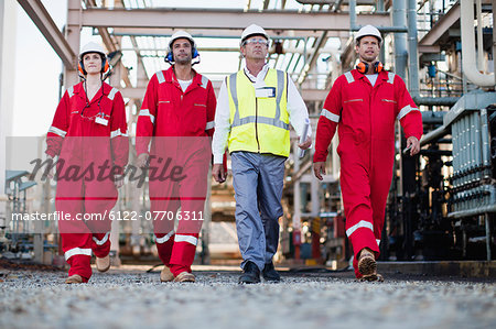 Workers walking at chemical plant Workers walking at chemical plant
