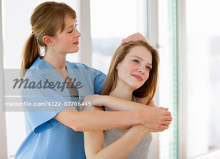 Doctor examining girl in office