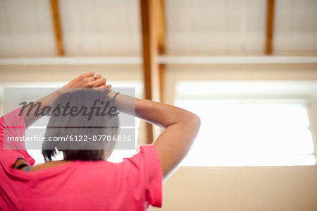 Woman resting hands on her head