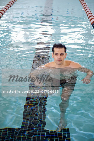 Man treading water in swimming pool