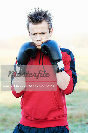 Boxer holding up gloves outdoors