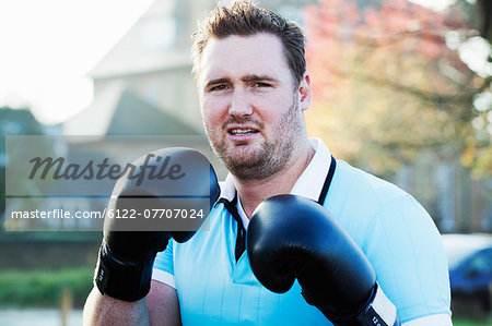 Boxer holding up gloves outdoors