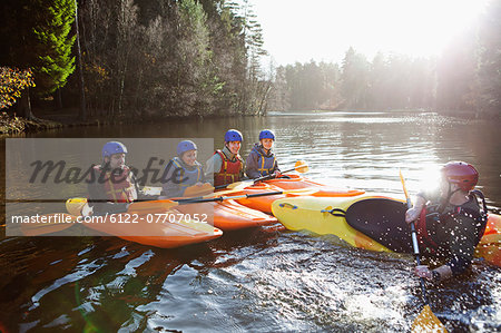 Teacher capsizing kayak in still lake