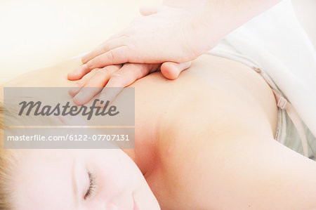 Woman having back massage in spa