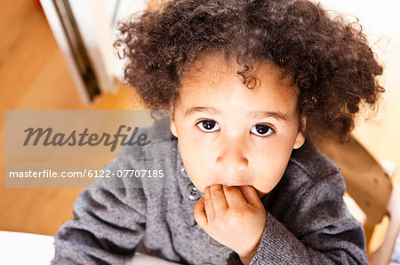 Close up of girl with fingers in mouth