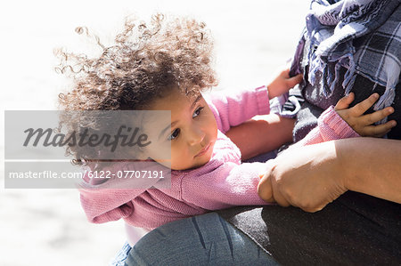 Close up of girl hugging mother outdoors