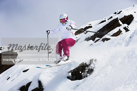 Skier jumping on snowy slope