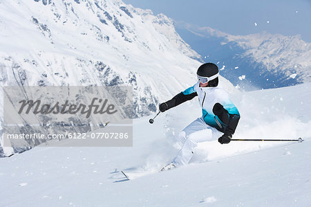 Skier coasting on snowy slope