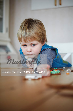 Girl decorating gingerbread cookies