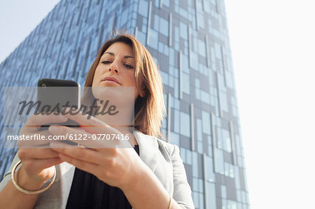 Businesspeople using cell phone outdoors