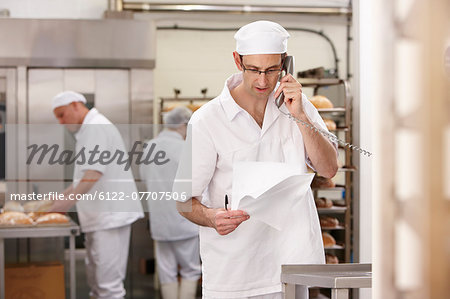Chef talking on phone in kitchen