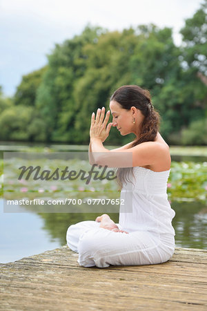 Mature Woman doing Yoga in Park in Summer, Bavaria, Germany