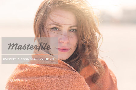 Close up portrait of young woman wrapped in blanket Close up portrait of young woman wrapped in blanket