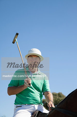 Portrait of mature man playing polo