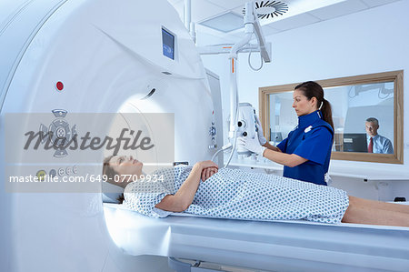 Woman going into CT scanner Woman going into CT scanner