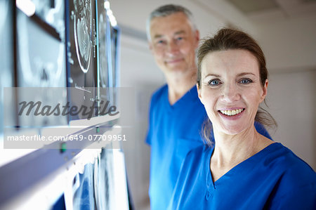 Portrait of radiologists with brain scans Portrait of radiologists with brain scans